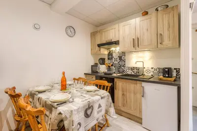 a kitchen with a table with a table cloth on it at La Maisonnée de Julie - Happy Rentals in Chamonix-Mont-Blanc