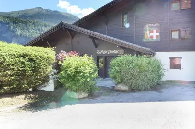 a building with bushes in front of it at Prarion ski in ski out and swimming pool ! in Les Houches