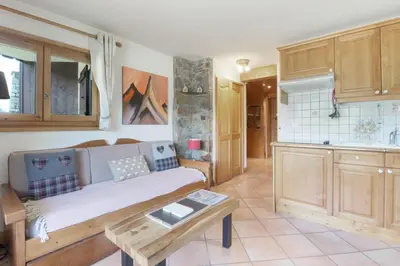 a living room with a couch and a table at Prarion ski in ski out and swimming pool ! in Les Houches