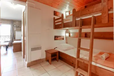 a room with a bunk bed and a desk at Prarion ski in ski out and swimming pool ! in Les Houches