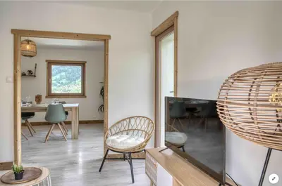 a living room with a mirror and a table at Chalet Mirador appartement vue panoramique SITUÉ À 25 kms de CHAMONIX in Saint-Gervais-les-Bains