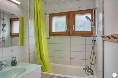 a bathroom with a tub and a sink and a shower at Chalet Mirador appartement vue panoramique SITUÉ À 25 kms de CHAMONIX in Saint-Gervais-les-Bains