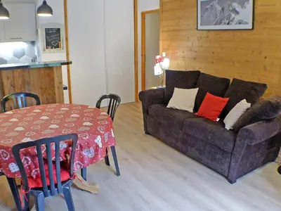 a living room with a couch and a table at Confortable 3 pièces avec terrasse, idéal pour 6 personnes - FR-1-629-100 in Samoëns