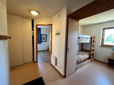 a small room with a bunk bed and a hallway at Appartement lumineux au pied des pistes avec accès direct Grand Massif - FR-1-624-100 in Morillon
