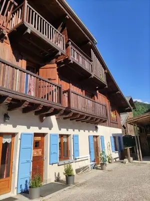 a building with wooden balconies on the side of it at Chalet La Ferme d'Henriette, à Samoëns in Samoëns