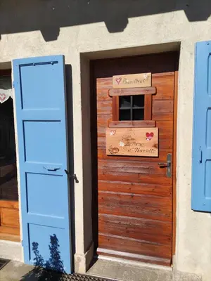 a door to a house with a sign on it at Chalet La Ferme d'Henriette, à Samoëns in Samoëns