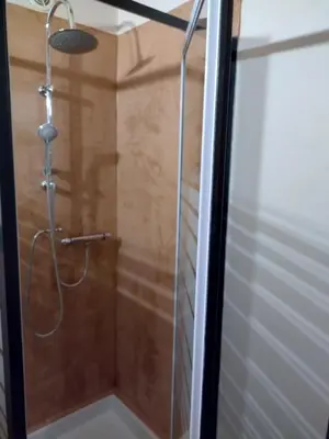 a shower with a glass door in a bathroom at Chalet La Ferme d'Henriette, à Samoëns in Samoëns