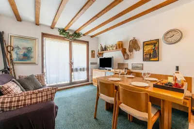 a living room with a dining room table and a couch at Appartement Des Lacs - Happy Rentals in Chamonix-Mont-Blanc