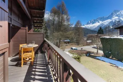 a balcony with a table and a view of a mountain at Chalet Charousse in Les Houches