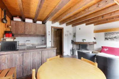 a kitchen with a wooden table in a room at Chalet Charousse in Les Houches