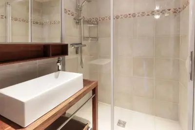 a bathroom with a white sink and a shower at Chalet Charousse in Les Houches