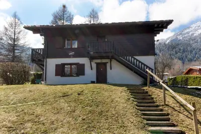 a house with a staircase leading up to it at Chalet Charousse in Les Houches