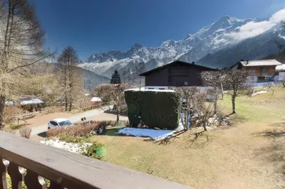 a view from a balcony of a house with mountains at Chalet Charousse in Les Houches