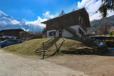 a house on a hill with stairs in front of it at Chalet Charousse in Les Houches