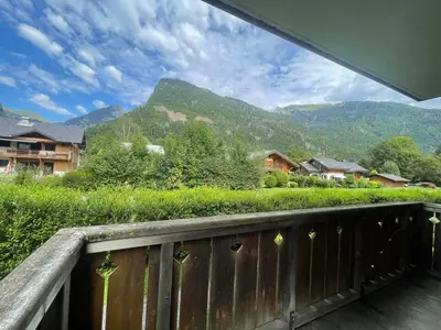 a balcony with a view of a mountain at Appartement calme à Samoëns avec piscine et WiFi - FR-1-624-101 in Samoëns