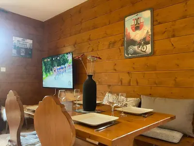a wooden room with a table with a vase on it at Appartement calme à Samoëns avec piscine et WiFi - FR-1-624-101 in Samoëns