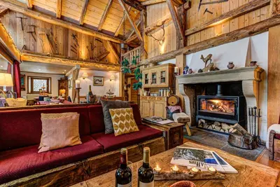 a living room with a couch and a fireplace at Chalet Tissières in Chamonix-Mont-Blanc