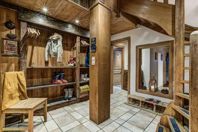 a room with wooden walls and a table and a chair at Chalet Tissières in Chamonix-Mont-Blanc