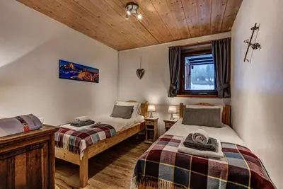 a bedroom with two beds and a window at Chalet Tissières in Chamonix-Mont-Blanc