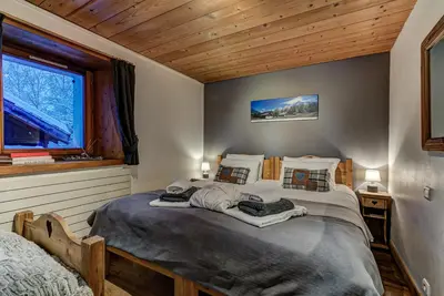 a bedroom with a large bed and a window at Chalet Tissières in Chamonix-Mont-Blanc