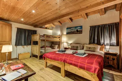 a bedroom with two bunk beds and a table at Chalet Tissières in Chamonix-Mont-Blanc