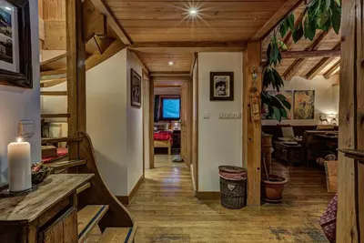 a hallway in a house with wooden ceilings and a dining room at Chalet Tissières in Chamonix-Mont-Blanc