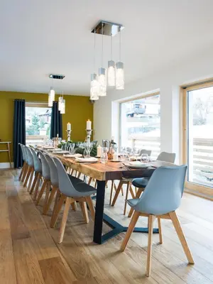 a dining room with a long table and chairs at Chalet Rubicon in Les Houches