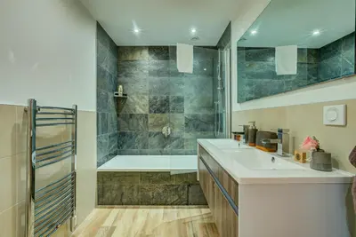 a bathroom with a tub and a sink and a shower at Chalet Rubicon in Les Houches
