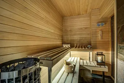 a sauna with a bench and a table in it at Chalet Rubicon in Les Houches