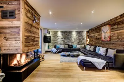 a living room with a couch and a fireplace at Chalet Rubicon in Les Houches