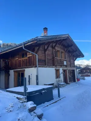 a large wooden building with snow on the ground at Vielyterra - Chalet haut de gamme - Domaine du mont blanc in Saint-Gervais-les-Bains