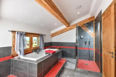 a bathroom with a shower and a bath tub at Vielyterra - Chalet haut de gamme - Domaine du mont blanc in Saint-Gervais-les-Bains