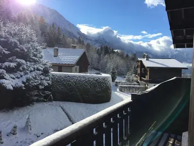 a view from a balcony of a snow covered mountain at Appartement cosy au pied du MtBlanc in Chamonix-Mont-Blanc