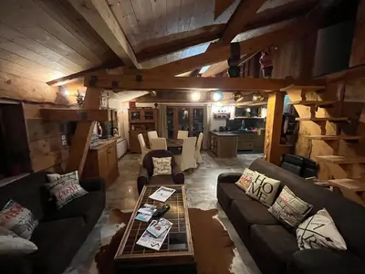 a living room with couches and a table at CHALET TOUDBIOLE haut de chalet in Les Houches