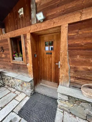 a wooden front door of a wooden house at CHALET TOUDBIOLE haut de chalet in Les Houches