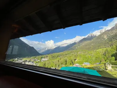 a window in a train looking out at the mountains at CHALET TOUDBIOLE haut de chalet in Les Houches