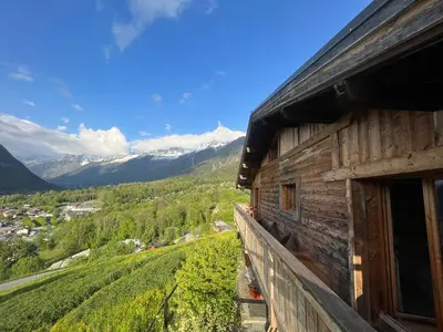 a wooden building with a view of a mountain at CHALET TOUDBIOLE haut de chalet in Les Houches