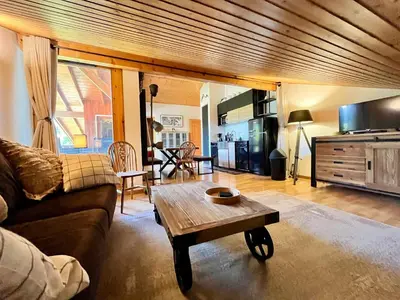 a living room with a couch and a coffee table at Appartement familial avec piscines à Samoëns - FR-1-624-103 in Samoëns