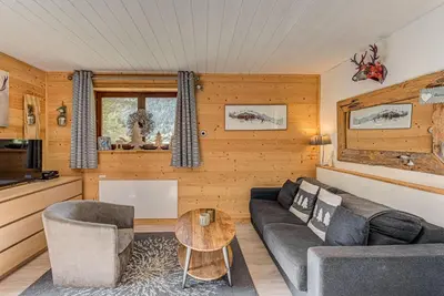 a living room with a couch and a table at Apartment Cry - Alpes Travel - Central Chamonix (sleeps 2-4) in Chamonix-Mont-Blanc
