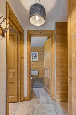 a hallway with wood paneling and a door with a closet at Apartment Cry - Alpes Travel - Central Chamonix (sleeps 2-4) in Chamonix-Mont-Blanc