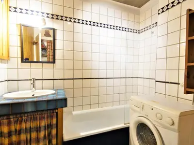 a bathroom with a sink and a washing machine at Apartment Arve 1 et 2-4 by Interhome in Chamonix-Mont-Blanc