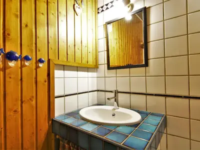 a bathroom with a sink and a mirror at Apartment Arve 1 et 2-4 by Interhome in Chamonix-Mont-Blanc