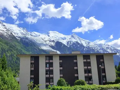 a building with a mountain in the background at Apartment Arve 1 et 2-4 by Interhome in Chamonix-Mont-Blanc