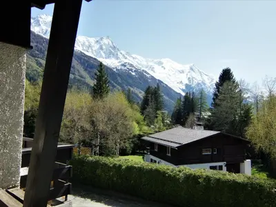 a building with a car parked in front of it at Apartment Alpen Roc by Interhome in Chamonix-Mont-Blanc