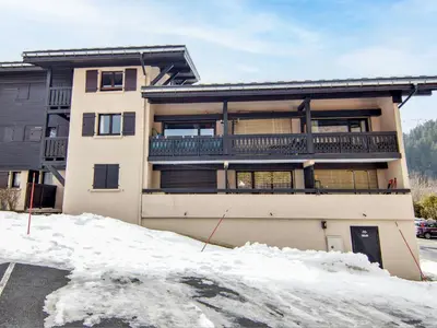 a apartment building with a balcony in the snow at Studio Les Arandellys by Interhome in Les Houches