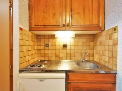 a small kitchen with a sink and a stove at Studio Les Arandellys by Interhome in Les Houches
