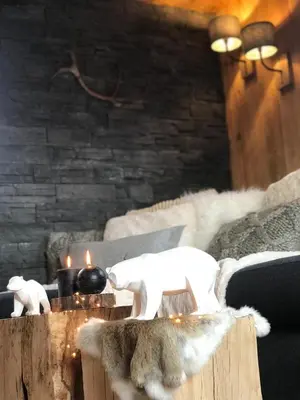 a room with a table with candles and animals on it at Charmant Mazot Le 1881 4 pers in Demi-Quartier