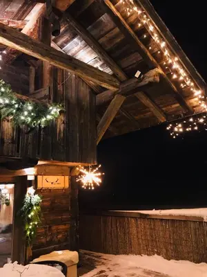 a barn with christmas lights on the ceiling at Charmant Mazot Le 1881 4 pers in Demi-Quartier