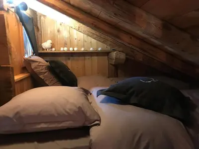 a bedroom with two pillows on a bed at Charmant Mazot Le 1881 4 pers in Demi-Quartier