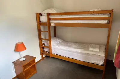 two bunk beds in a room with a lamp and a table at Apartment Of 55 M With Balcony View Mont Blanc in Chamonix-Mont-Blanc